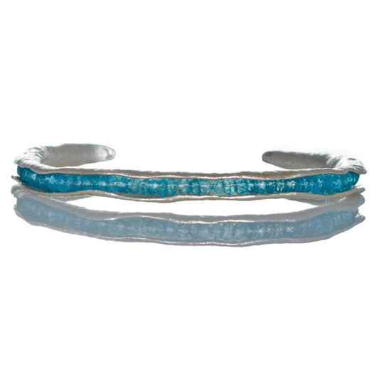 Silver pod cuff with blue topaz